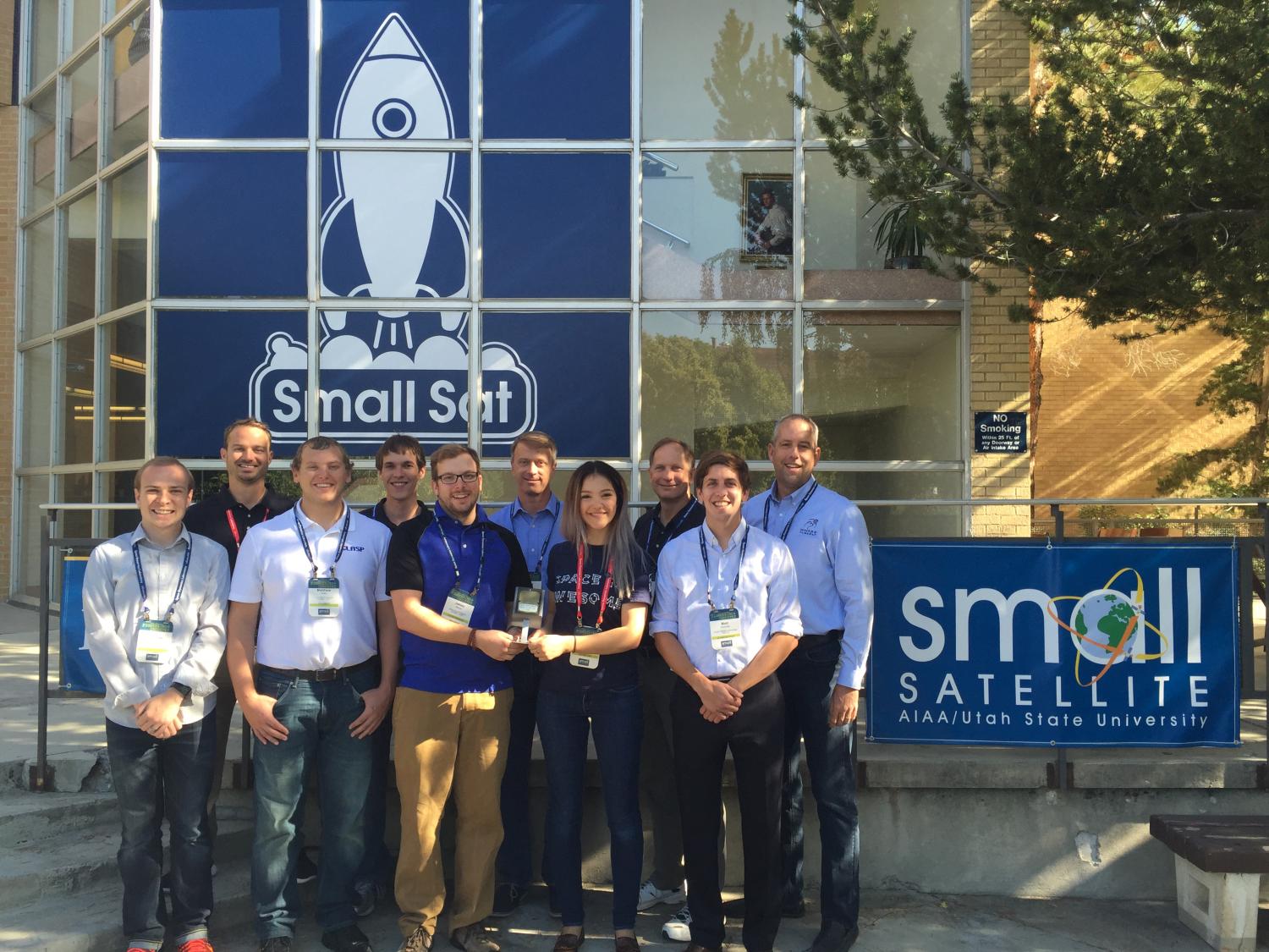 The MinXSS team outside the Small Sat conference with the award.