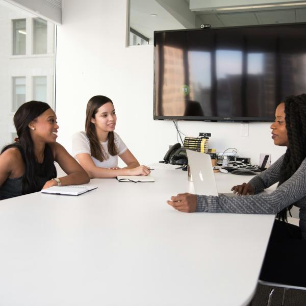 Three women holding a meeting in a conference room