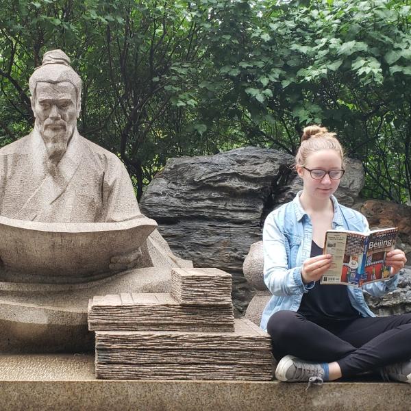 Student and statue in Beijing, China
