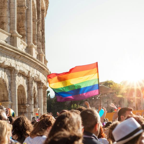 Pride flag in front of the Roman colosseum