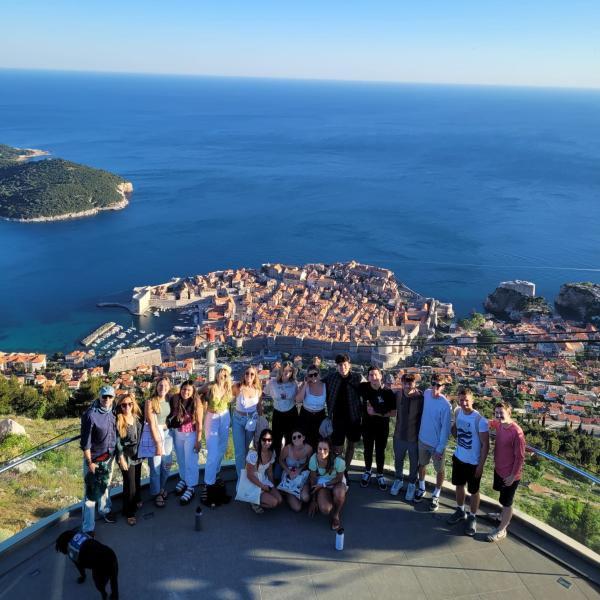 Group of students with Zagreb, Croatia city and ocean in the background