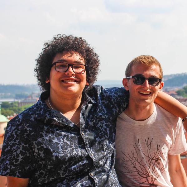 Two students in front of Prague skyline