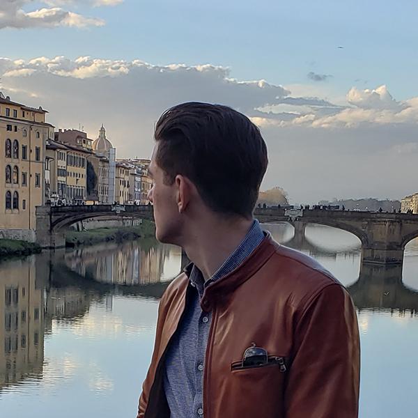 Student overlooking Arno River in Florence