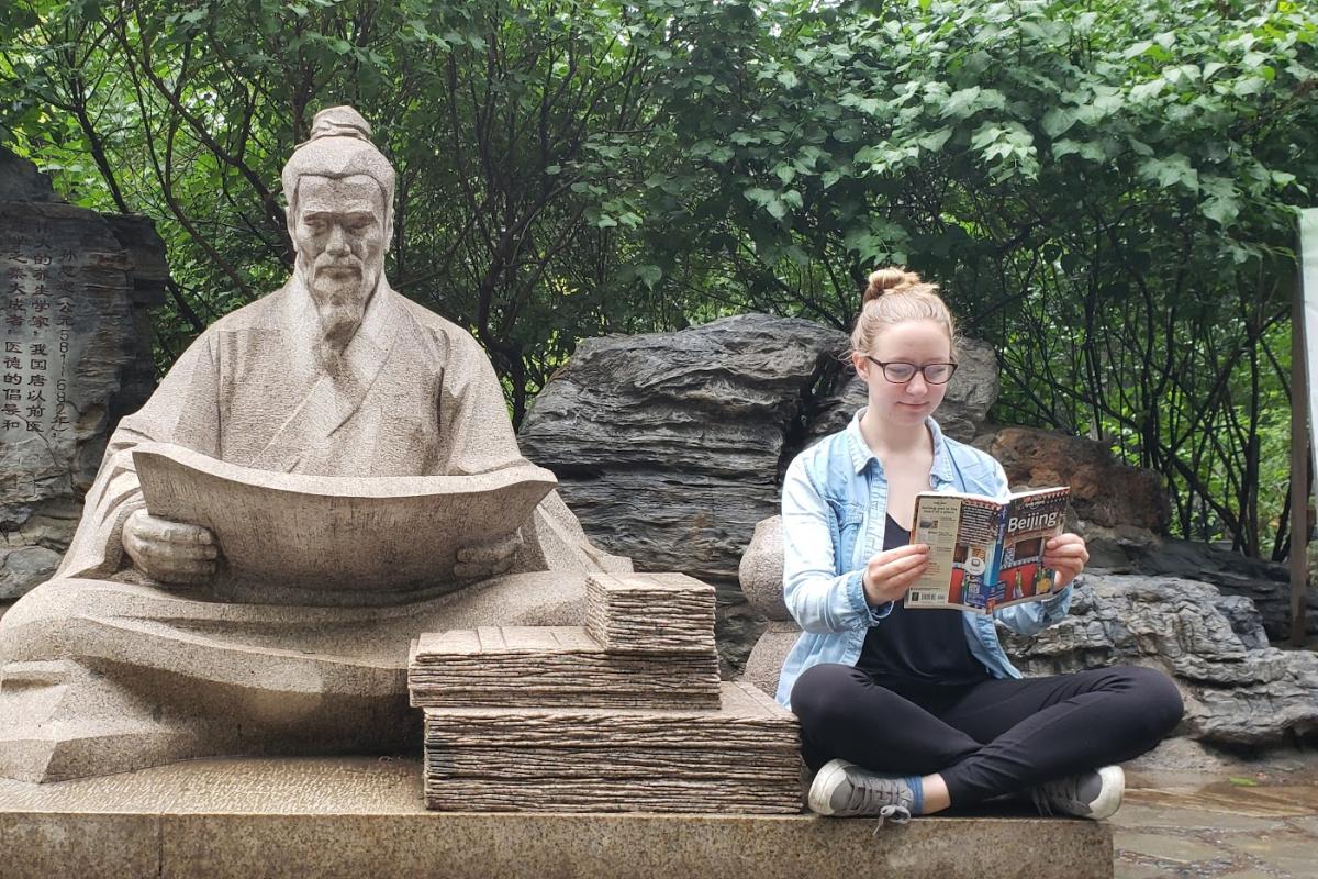 Student and statue in Beijing, China
