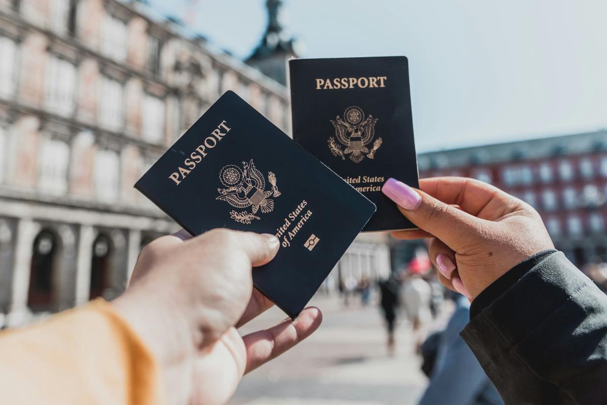 two people holding up passports