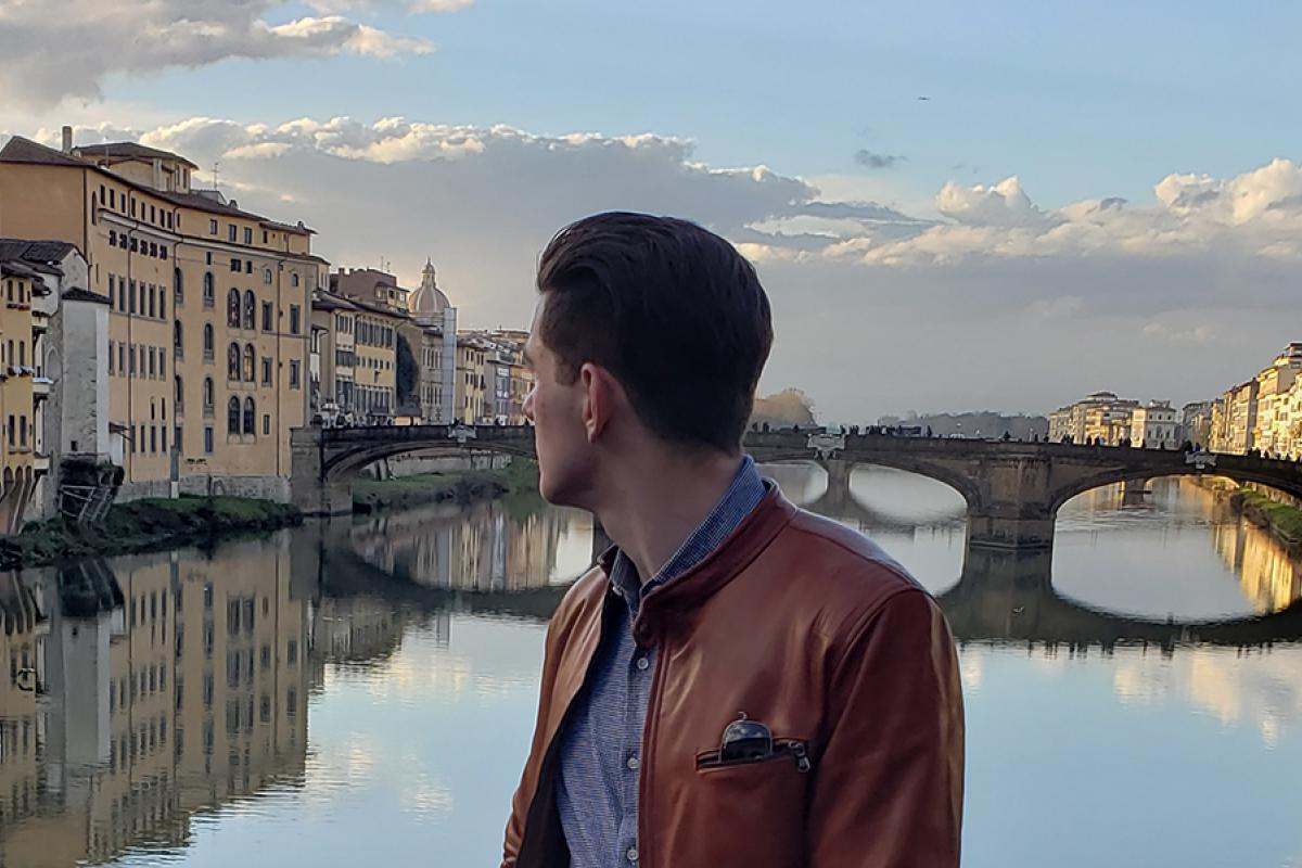Student overlooking Arno River in Florence
