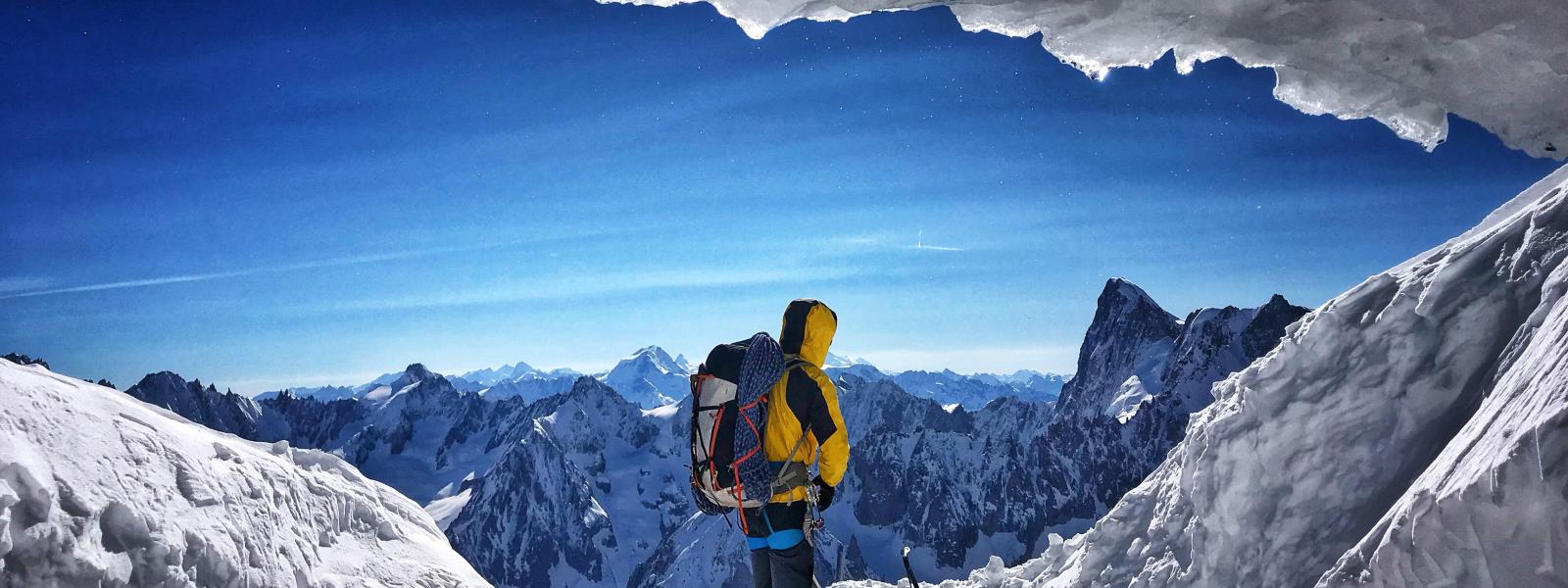 Hiker framed by mountain ice