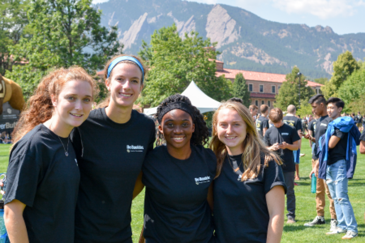 Students posing on campus with mountains in the background