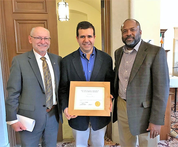Provost Russell L. Moore (left) and Smead Aerospace department chair Professor Brian M. Argrow with Professor Hussein at the 2017 Fall Convocation where Hussein received a Provost’s Faculty Achievement Award for Tenured Faculty.