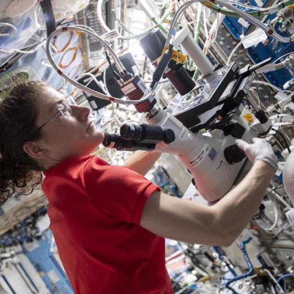 Astronaut Jessica Meir uses a microscope supplied by BioServe aboard the International Space Station.