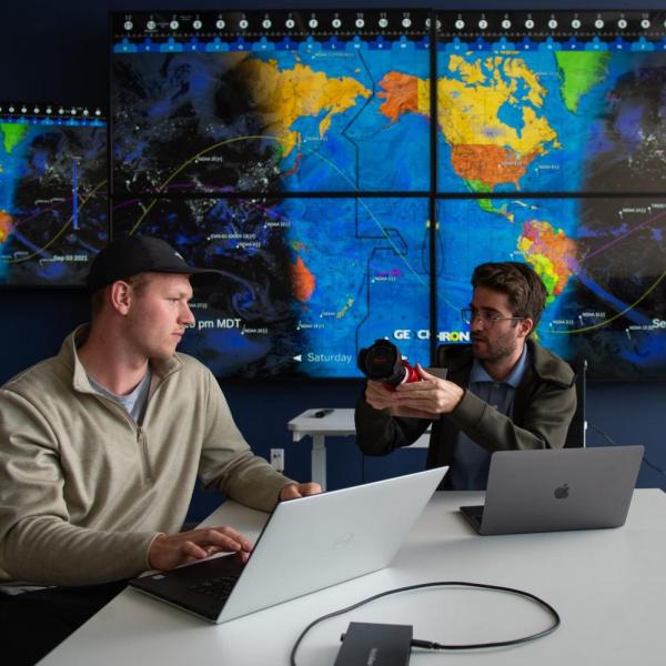 Graduate students Michael Klonowski, left, and Daniel Aguilar-Marsillach, right, work in the Raytheon Space & Intelligence Vision, Autonomy, and Decision Research Lab at CU Boulder, which studies new methods for tracking and managing satellite traffic in space.