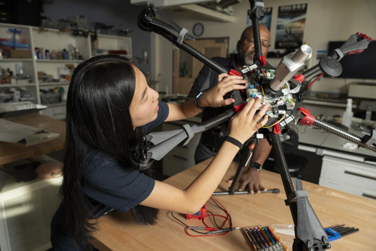 Student and faculty member with multi rotor drone.