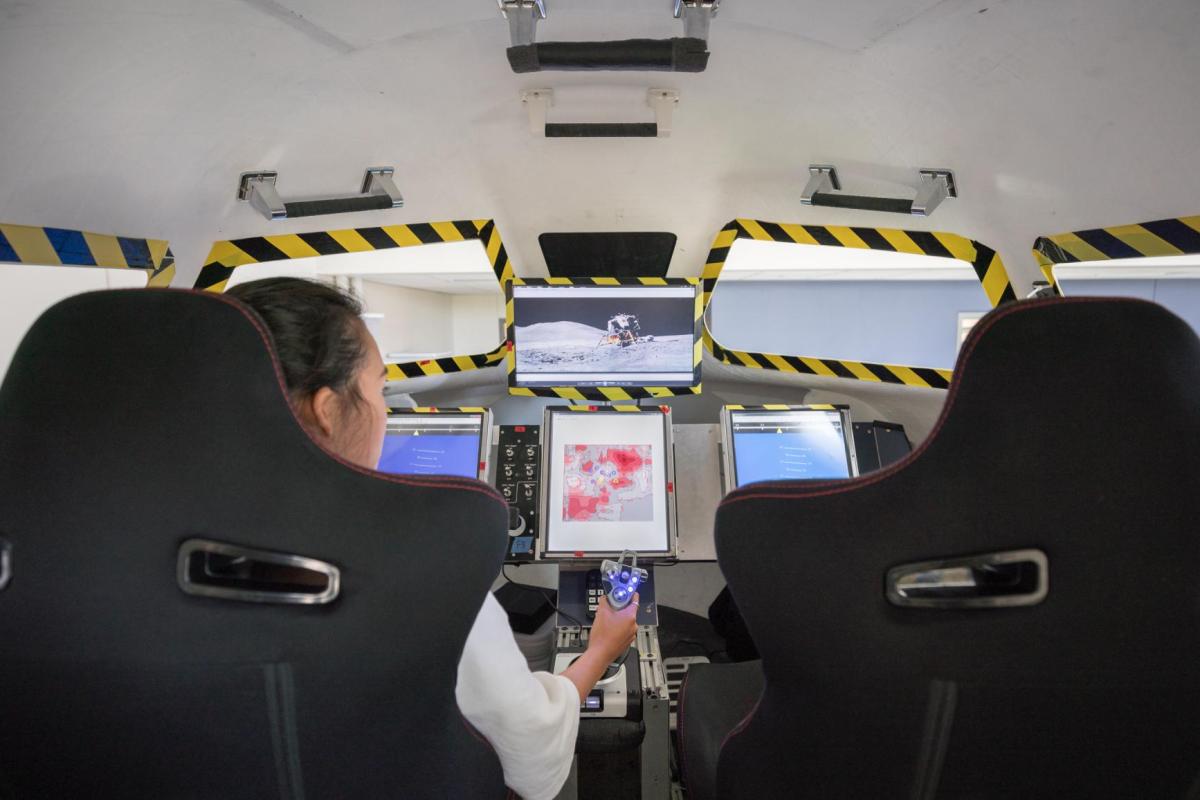 Student in the Dream Chaser simulator.