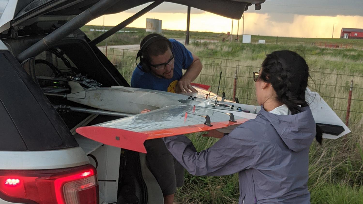 Inspecting a RAAVEN drone while on deployment.