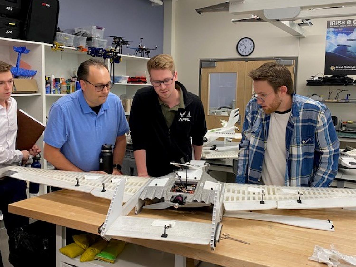 Inspecting a RAAVEN drone.