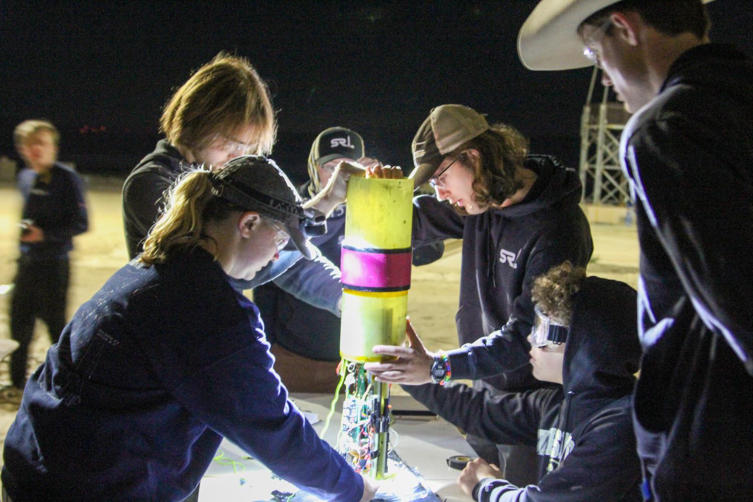 Team members performing final avionics bay integration.