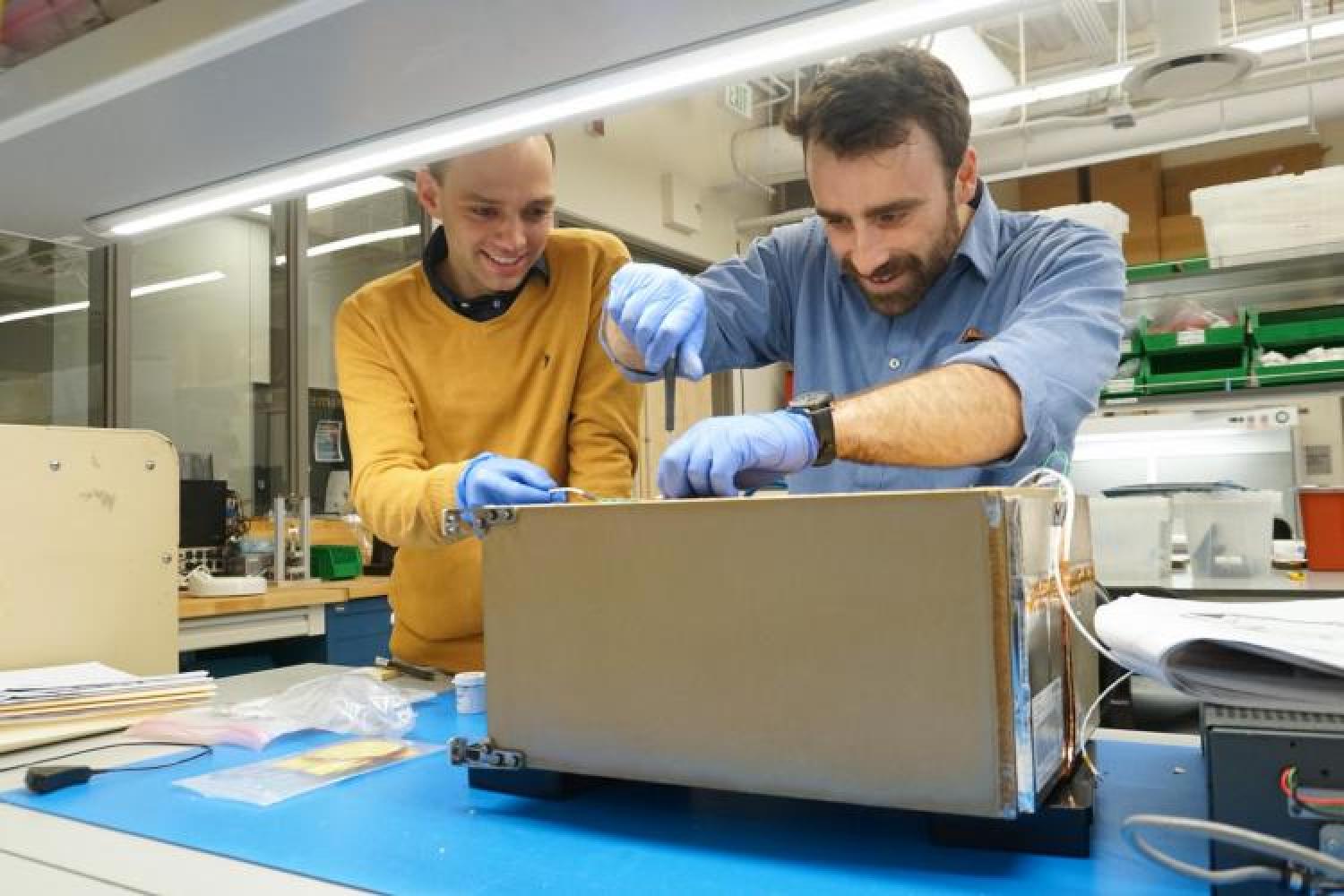 Tobias Niederwieser and Robby Aaron working on one of the FRIDGE units.