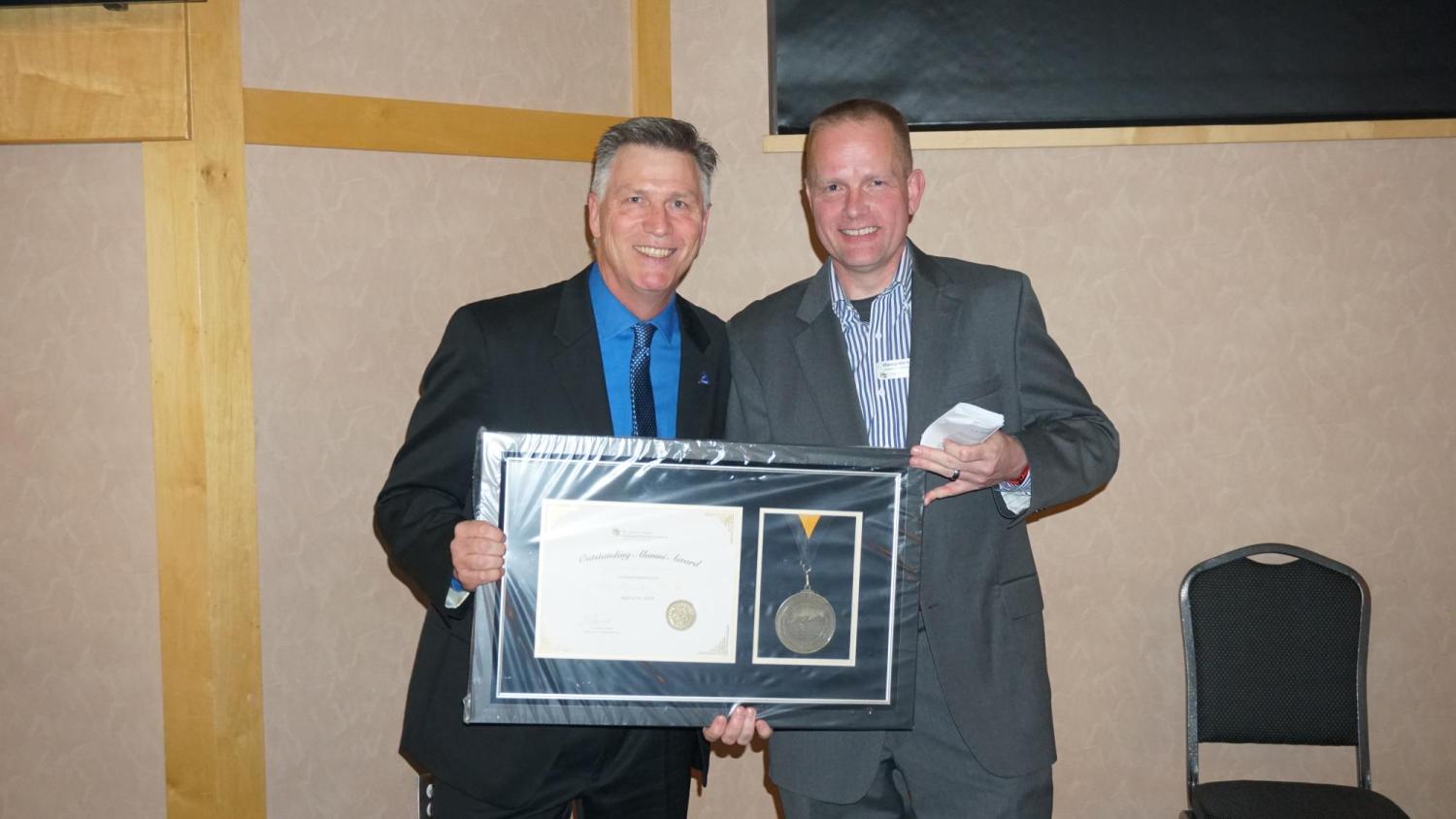 Tim Straube receiving his plaque and medal.