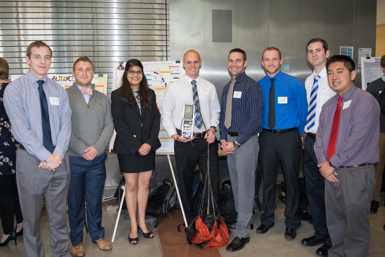 A group of senior design students standing together.
