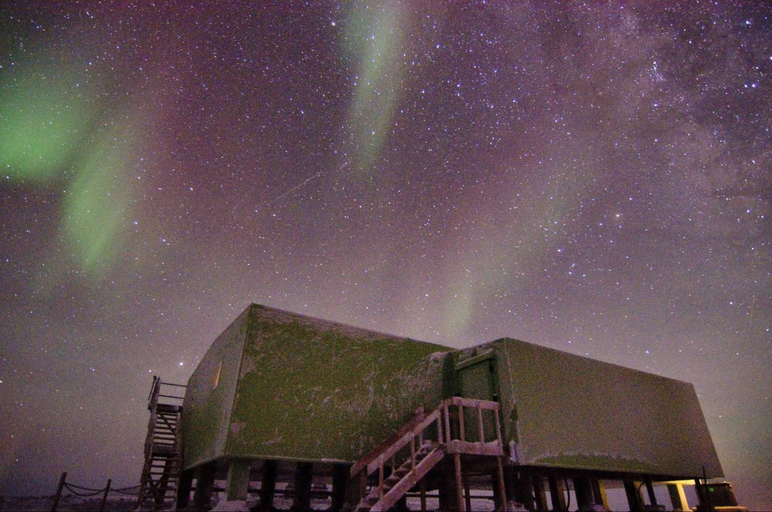 The aurora borealis over a building.