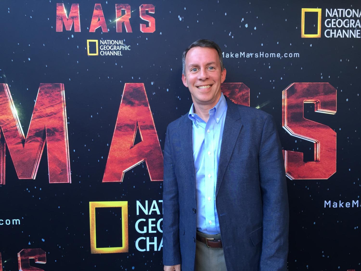 Bobby Braun in front of a National Geographic sign saying 'Mars'.