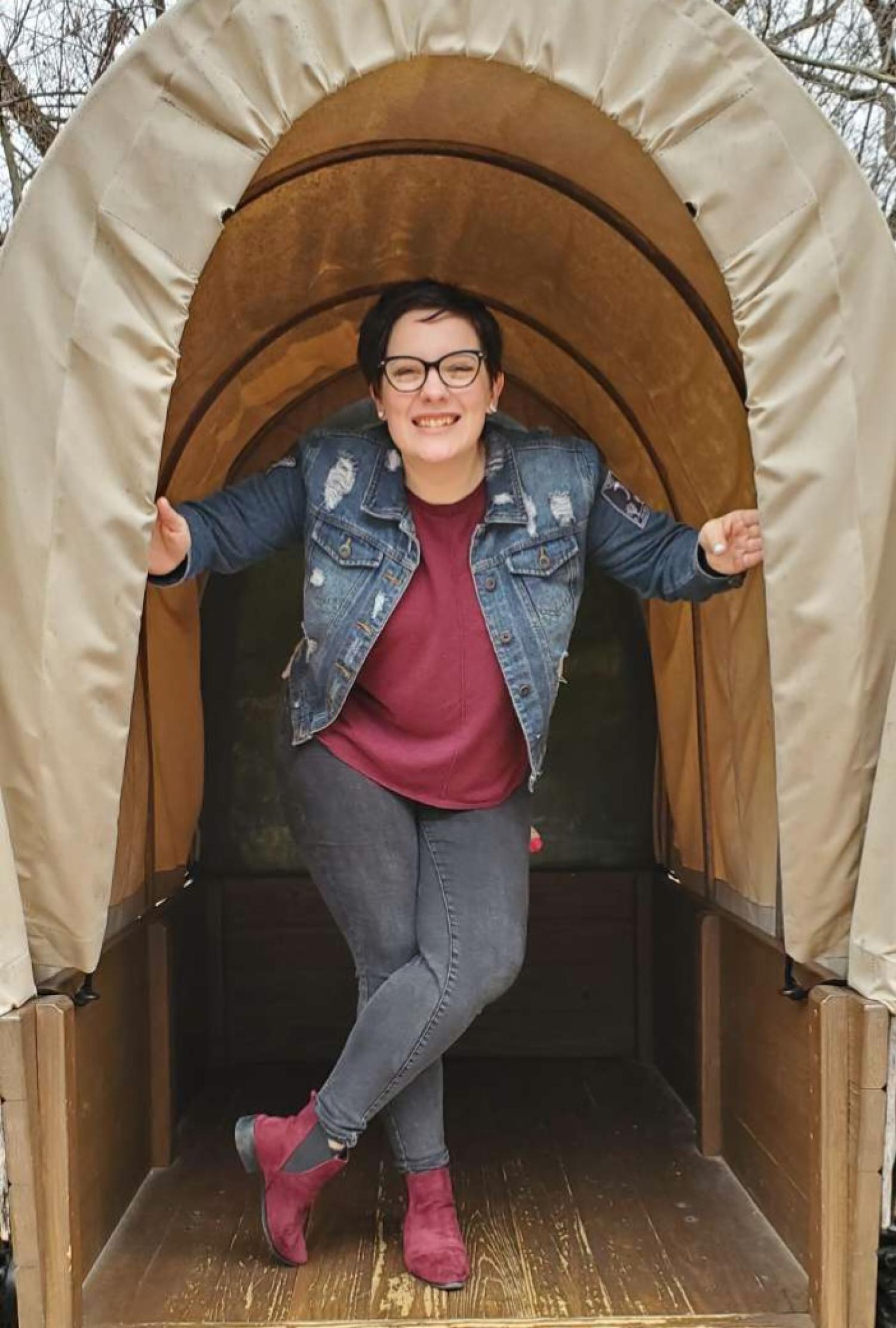 Becca Mikula in a covered wagon.