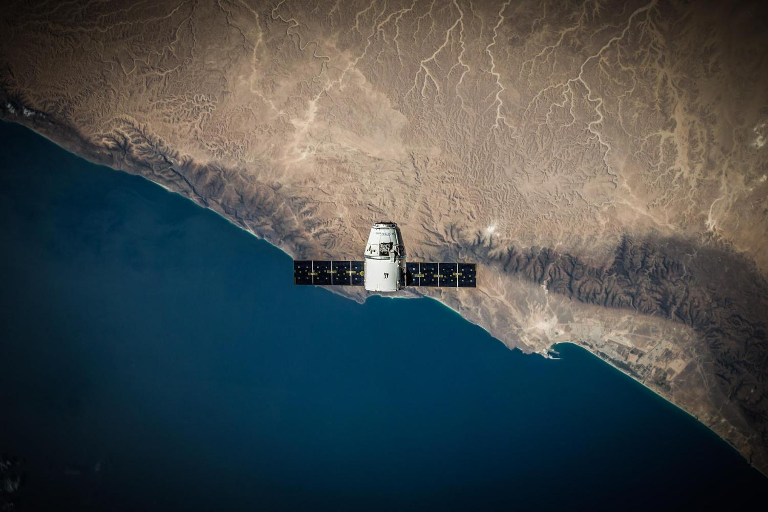 SpaceX capsule floating over Earth.
