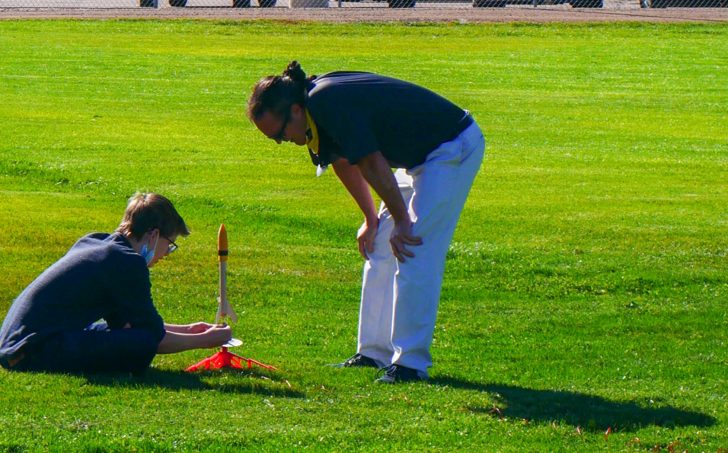 Matt Rhode with a student and their rocket.