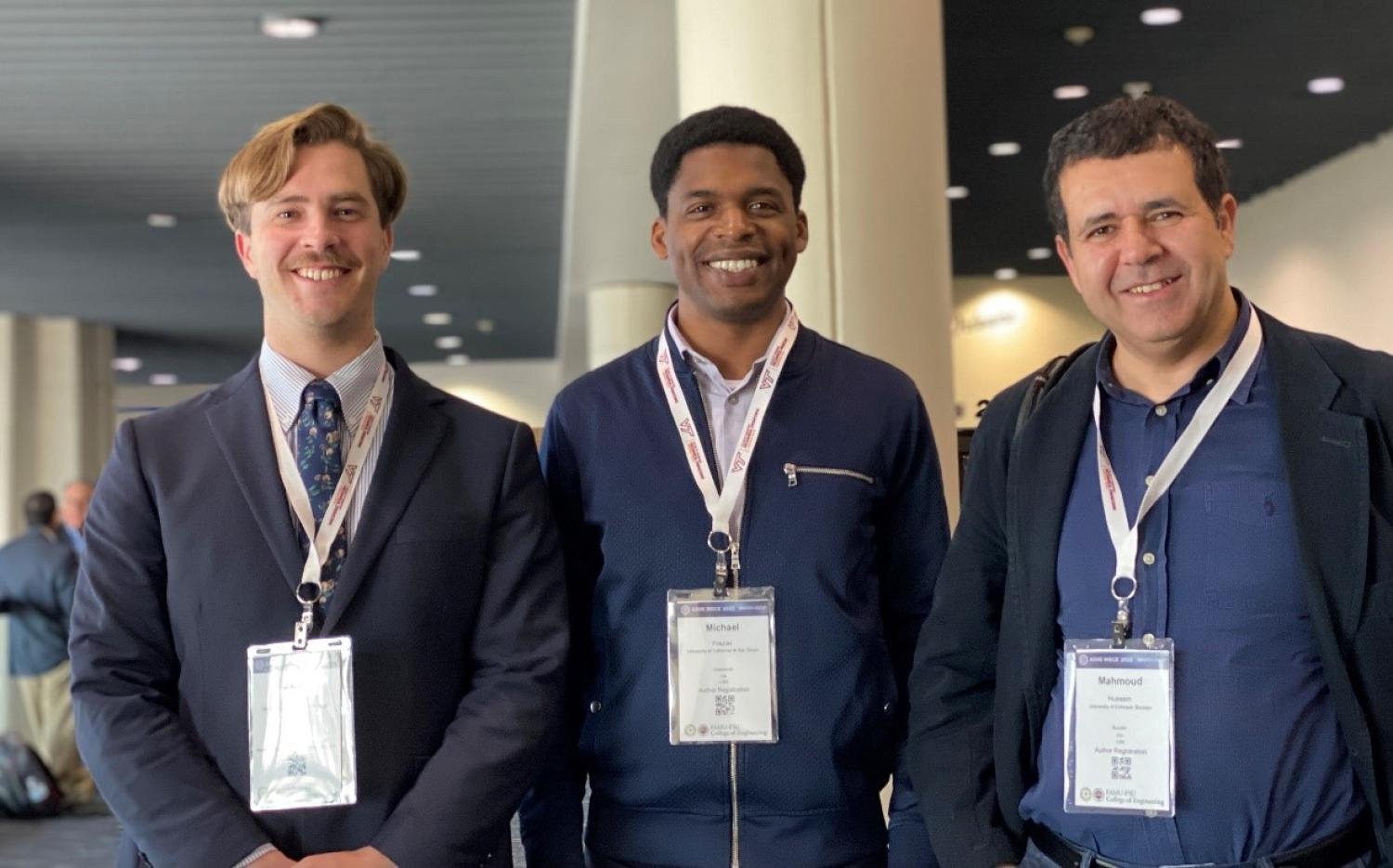 Michael J. Frazier (center) with his PhD advisor Mahmoud Hussein (right) and his PhD advisee Jack Pechac at the ASME IMECE 2023 conference.