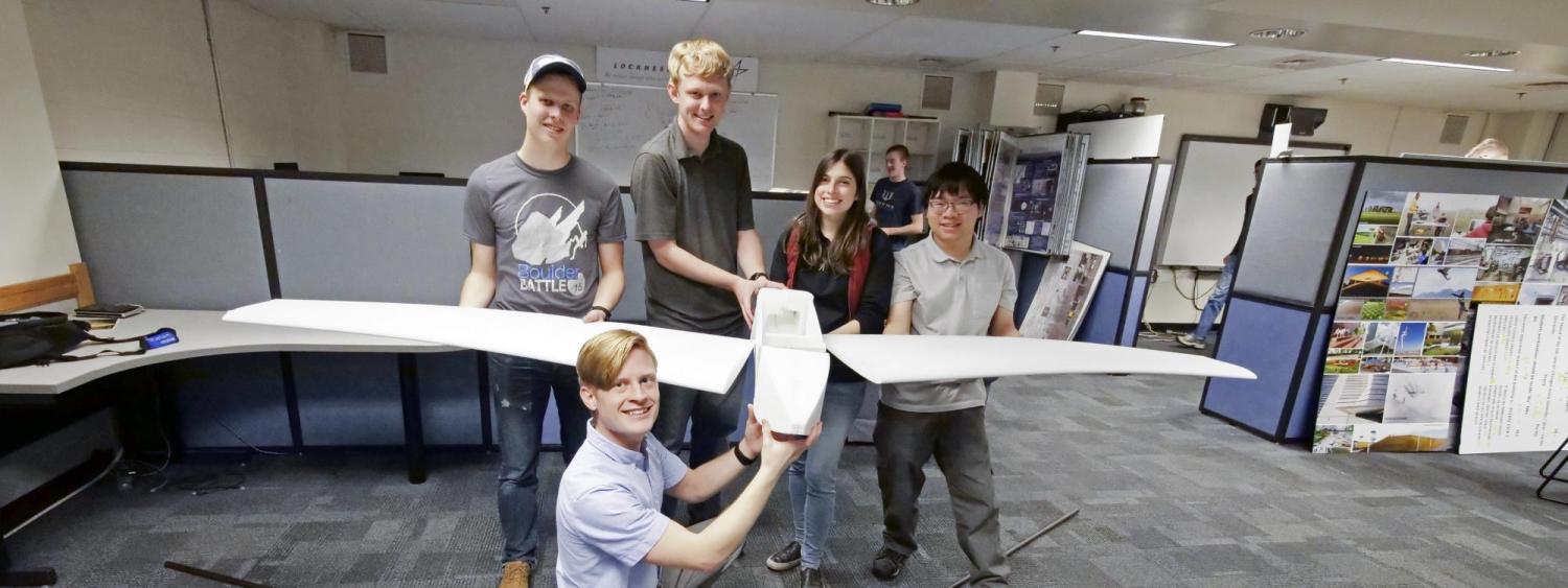 Students holding the drone.