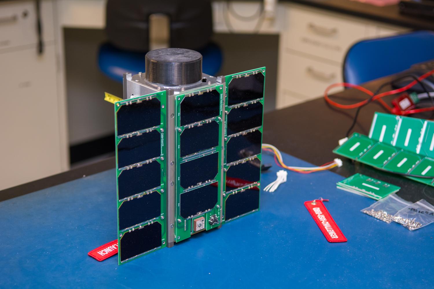 A CubeSat on a workbench.