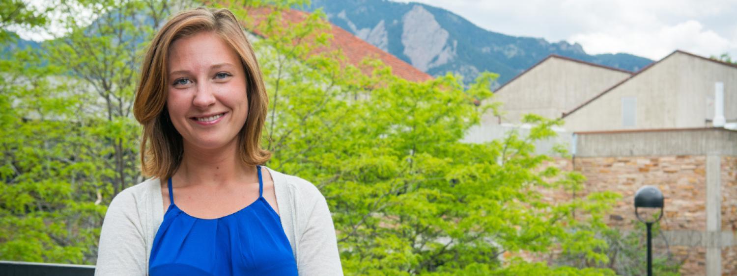 Nicole Ela outside the Engineering Center with the Flatirons in the background.