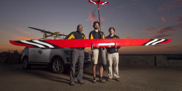 Brian Argrow with two students and a large UAV.