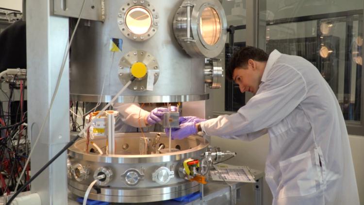 Researcher Julian Hammerl photographed next to the ECLIPS machine at CU Boulder.