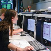 Students in the mission operations center at the Laboratory for Atmospheric and Space Physics in Colorado communicate with a satellite.