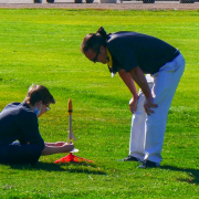 Matt Rhode with a student and their rocket.