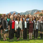 The Women in Aerospace Symposium attendees standing for a photo outside with the Flatirons in the background.