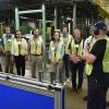 A group of students in the High-Speed Beverage Can Manufacturing Golden, Colorado, with a Ball employee.