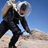 Shayna Hume taking a rock sample.