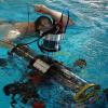 Student in the pool with the RoboSub system