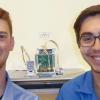 LASP graduate students Bennet Schwab (left) and Robert Sewell pose with the DAXSS flight unit. (Courtesy CU/LASP)