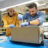 Tobias Niederwieser and Robby Aaron working on one of the FRIDGE units.