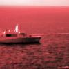 The USS Portland test-fires a laser weapon. The photo captured infrared light to make the beam visible. Staff Sgt. Donald Holbert/Marine Corps via AP
