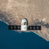 SpaceX capsule floating over Earth.
