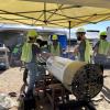 CU Hyperloop team members stand around their boring machine at a test site in Las Vegas.