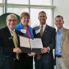 Phil DiStefano, Terri Fiez, Keoki Jackson, and Bobby Braun with the agreement.