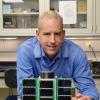 Scott Palo with the QB-50 CubeSat.