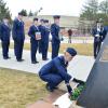 A student placing a wreath.