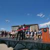 Donor Ann Smead cuts a ribbon lifted up by two flying drones.