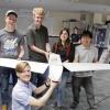 Students holding the drone.